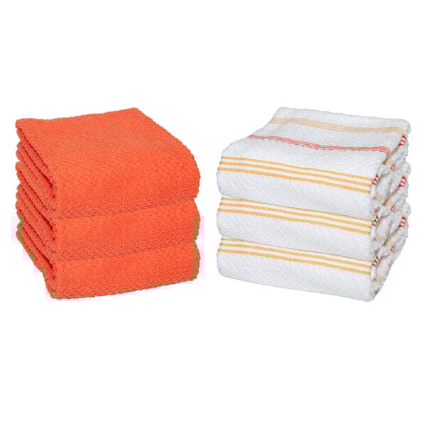 A stack of white towels with orange stripes.