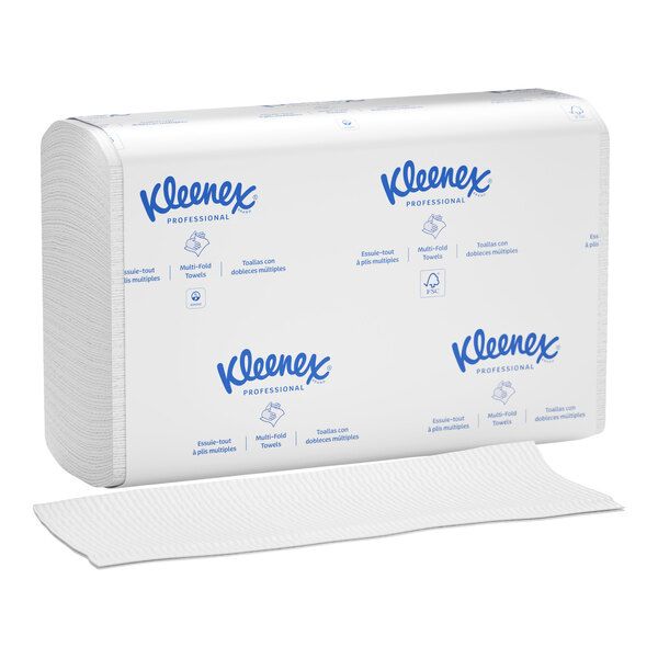A stack of white multi-fold paper towels with blue Kleenex branding on the packaging, with one towel partially pulled out.