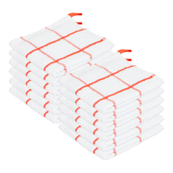 Two stacks of white dish cloths with red windowpane patterns and red hanging loops.