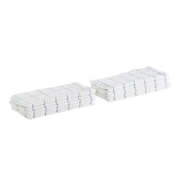 A stack of white Monarch Brands terry dish cloths with blue windowpane lines.