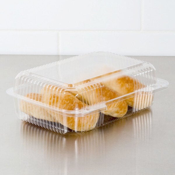A Dart clear hinged plastic container with food inside.