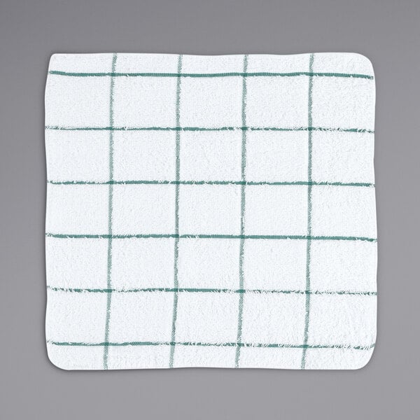 A white terry dish cloth with green windowpane lines.