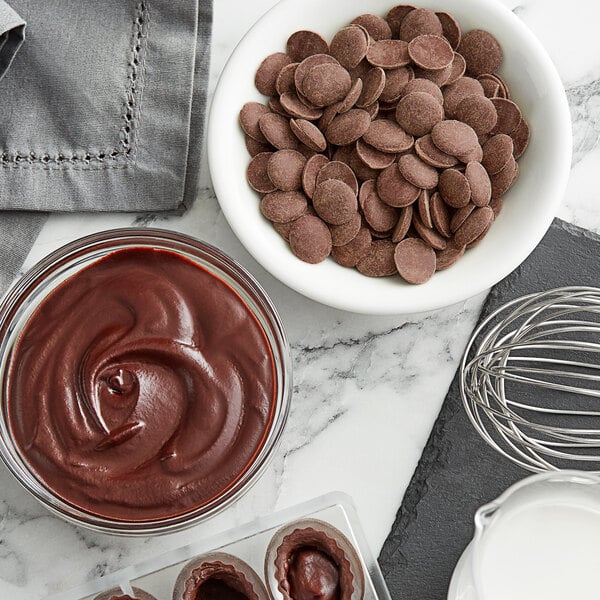A bowl of Cacao Barry Guayaquil dark chocolate pistoles.