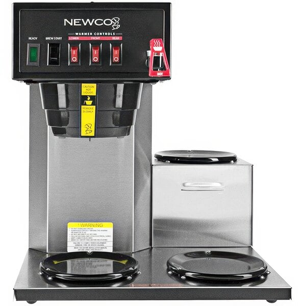 A Newco commercial coffee maker with black and silver decanters on a counter.