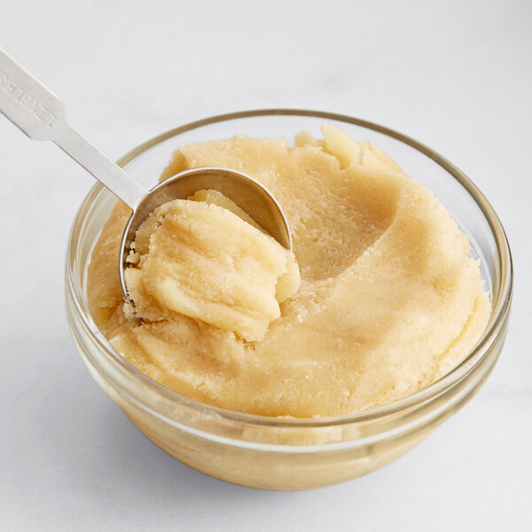 A spoonful of American Almond Macaroon Paste in a bowl.