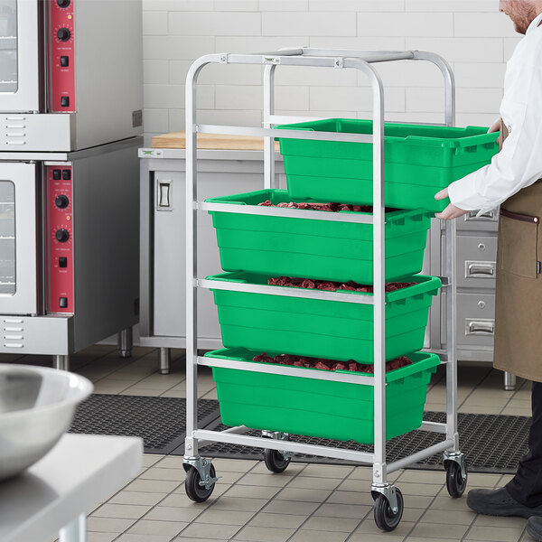 A man holding a metal rack with green meat lugs.