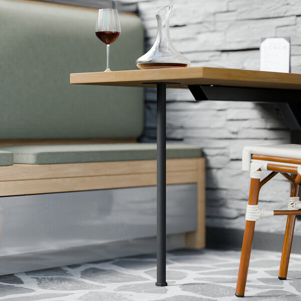 A table with a FLAT Tech standard height pin leg in a restaurant with a wine glass on it.