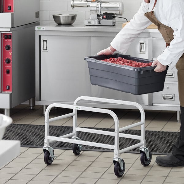 A man holding a Regency aluminum lug rack with a gray meat tote on it.