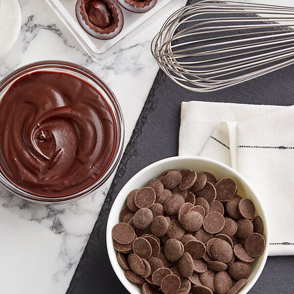 Dark chocolate couverture pistoles in a bowl