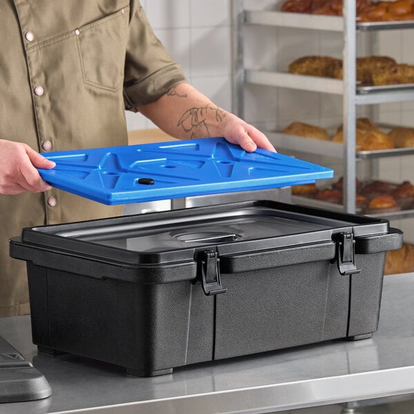 A black top-loading insulated food pan carrier with a blue ice board, designed to hold a full-size pan up to 6 inches deep.