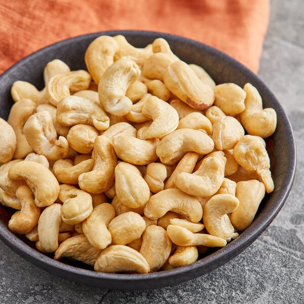 A bowl of Regal raw cashews on a table.