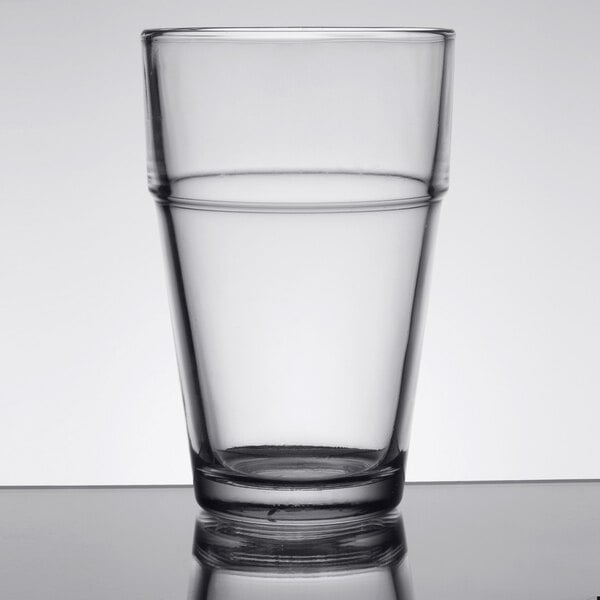An Anchor Hocking Stackable Beverage Glass filled with water on a table.