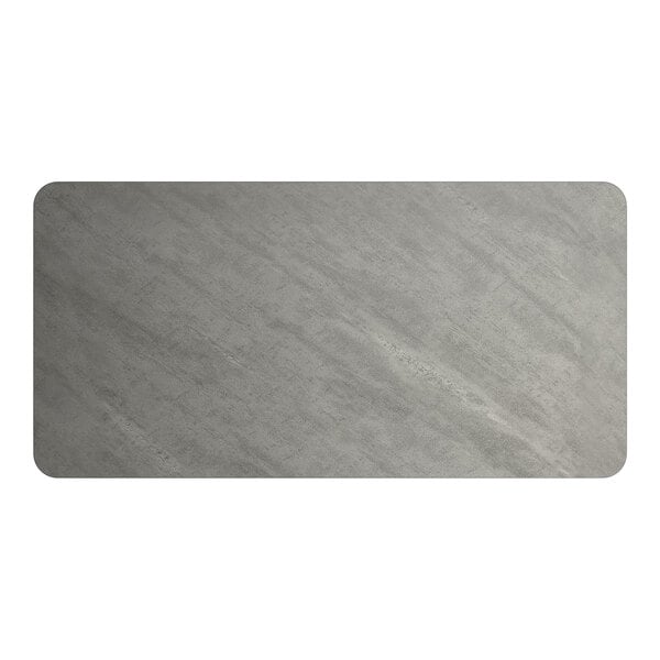 A rectangular reversible laminated table top with a white and gray slate finish.