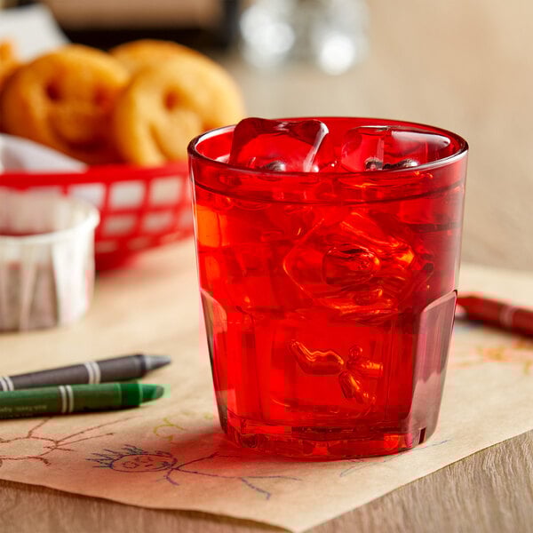 A red GET Bahama plastic tumbler with ice and red liquid and a red straw.