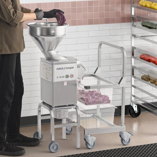 A commercial Robot Coupe CL55 food processor workstation with a continuous feed system, full moon pusher feed, bulk feed, and included discs.
