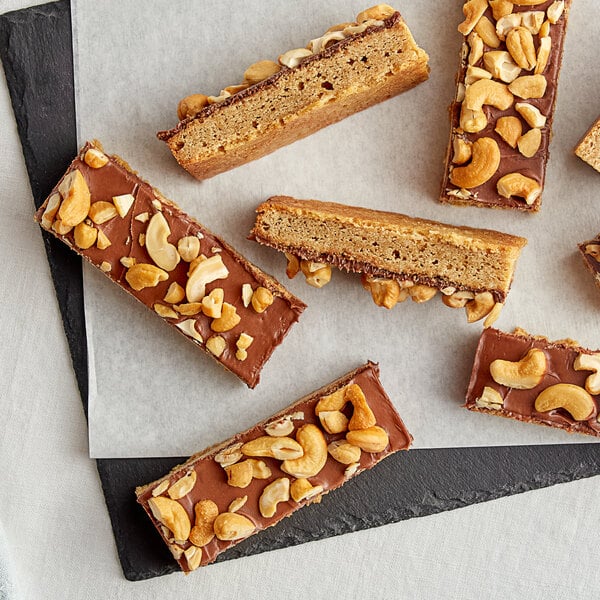 A piece of bread with chocolate spread and Large Roasted Salted Cashews on top.