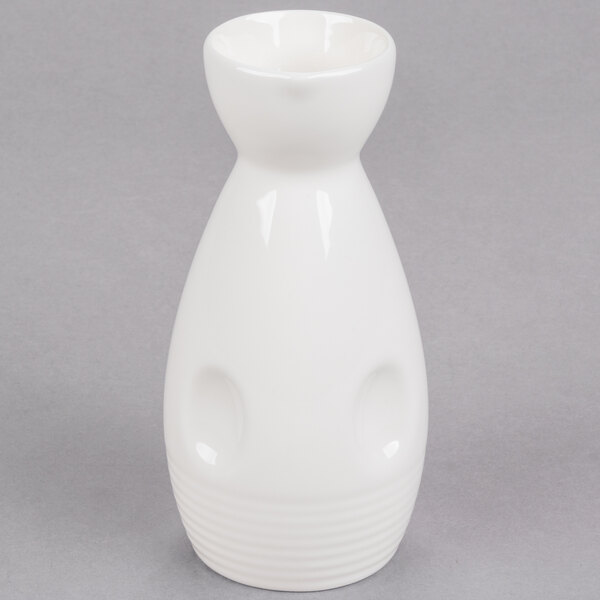 A close-up of a white porcelain Fuji Sake bottle with a handle.