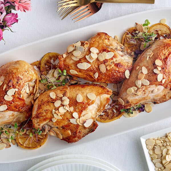 A chicken breast with Blanched Sliced Almonds on top of it.