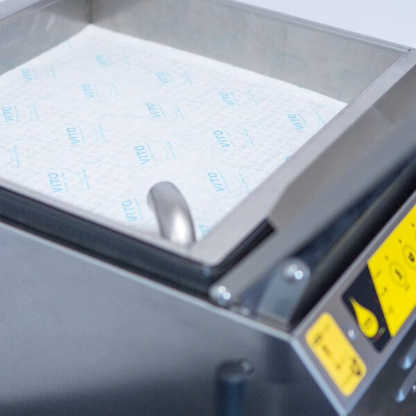 A VITO fryer oil filtration machine with a tray of paper towels on top.