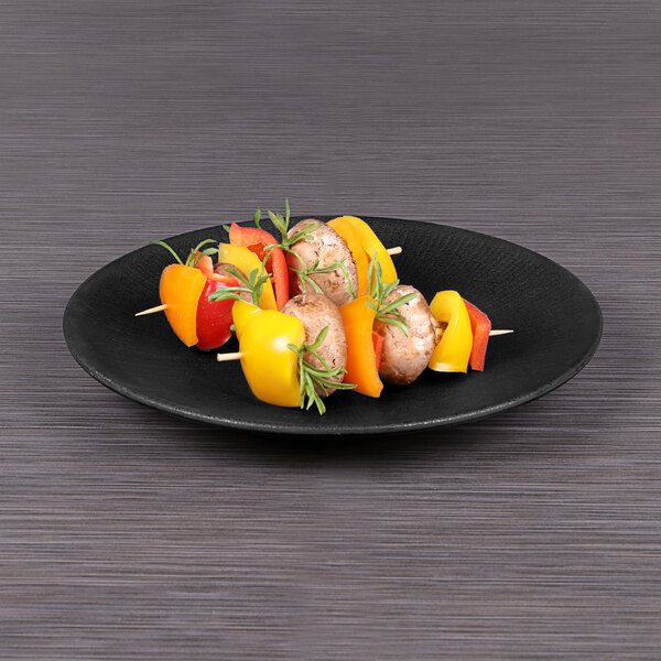 An Elite Global Solutions Hermosa matte black melamine plate with food on it.
