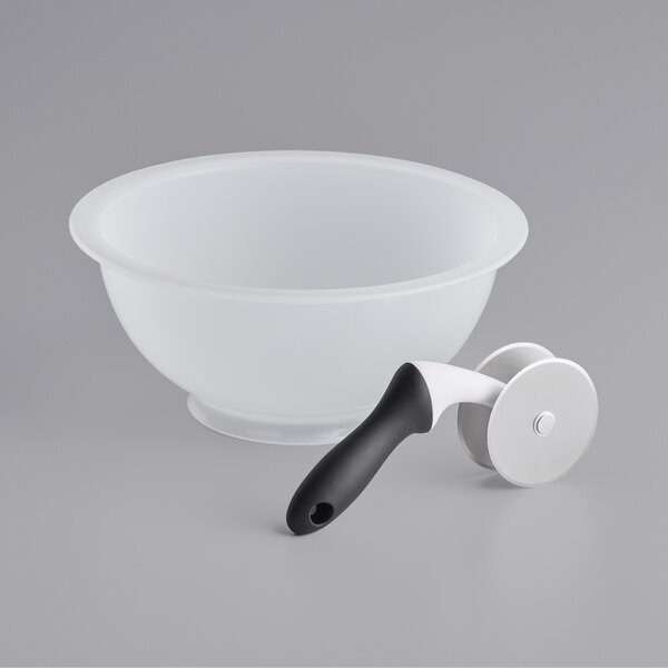 A white bowl with a black handle.