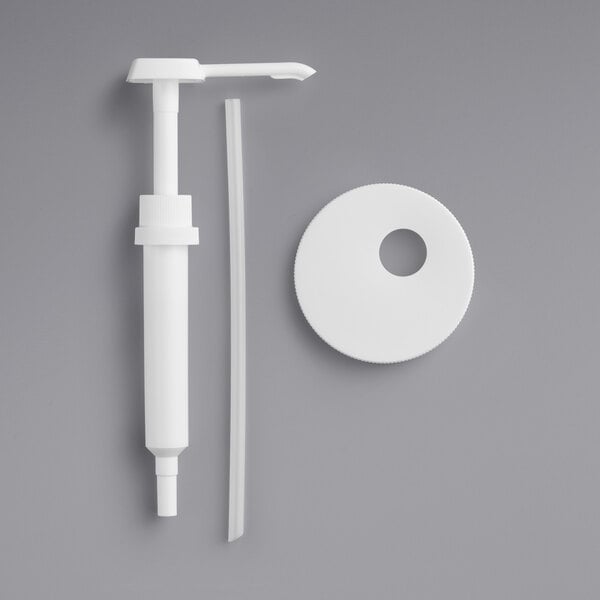 A white plastic pump with a Choice 1 oz. condiment pump and tube.