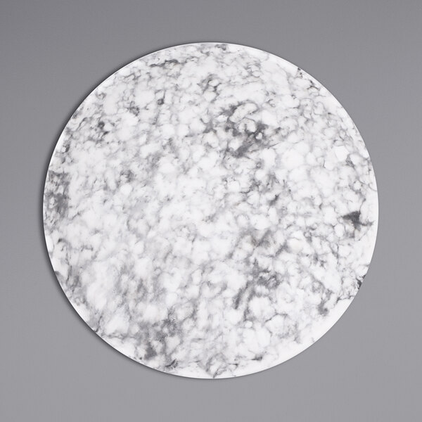 A white plate with a black and grey marbled surface.