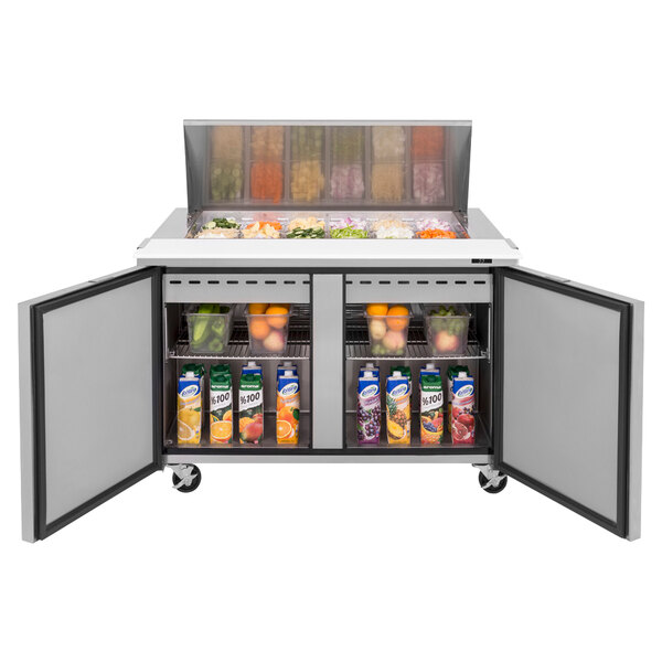 A Turbo Air 2 door mega top sandwich prep table with a variety of food inside.