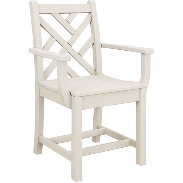 A white POLYWOOD Chippendale dining arm chair with a wooden frame.