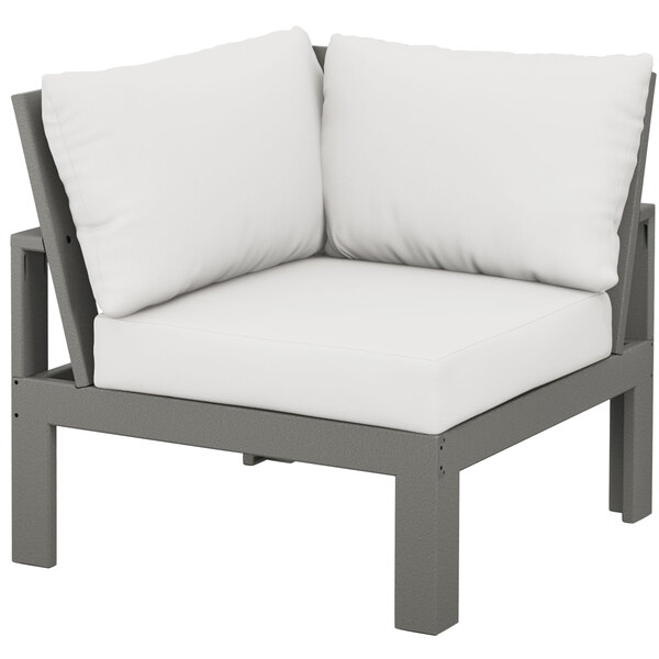 A POLYWOOD slate grey corner chair with a natural linen cushion.