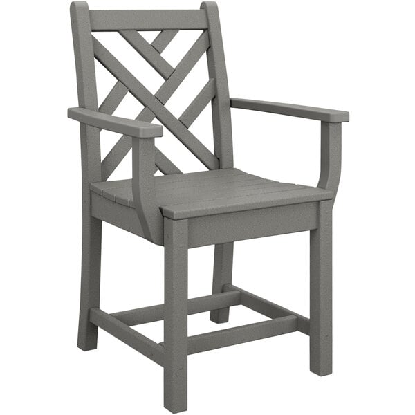 A POLYWOOD slate grey outdoor dining chair with wooden arms.