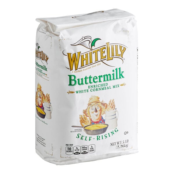 A 5 lb. bag of White Lily Buttermilk Enriched White Cornmeal Mix with self-rising properties, featuring colorful branding and an illustration of a person holding a bowl of cornbread.