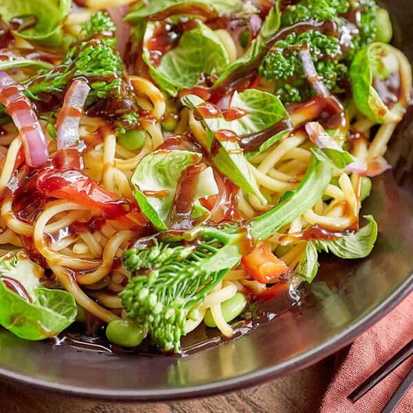 A bowl of noodles with broccoli and Lee Kum Kee Vegetarian Hoisin Sauce.