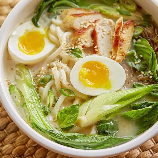 A bowl of Lee Kum Kee Japanese-style pork bone soup with meat, eggs, and noodles.