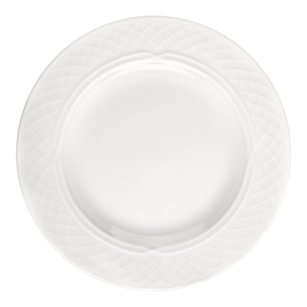 A round, bright white plate with a textured, lattice-like pattern around the rim.
