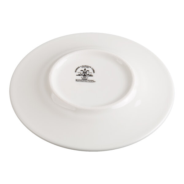 A white ceramic plate shown upside down, displaying a manufacturer's mark in the center.
