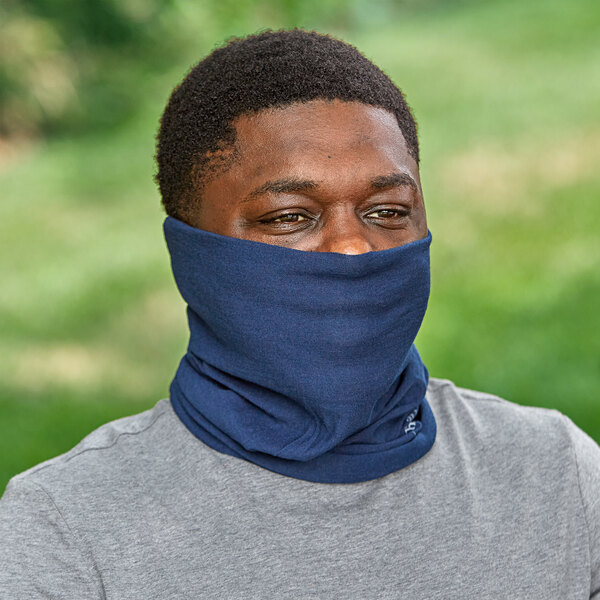 A man wearing a navy blue Ergodyne Chill-Its multi-band face covering over his neck and face.