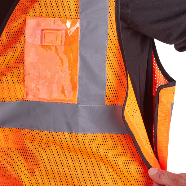 An orange Ergodyne safety vest with reflective tape.