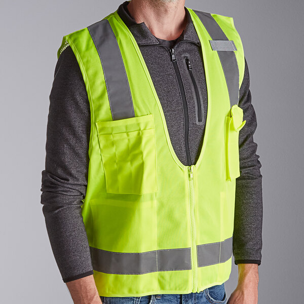 A man wearing a lime Ergodyne surveyor vest.