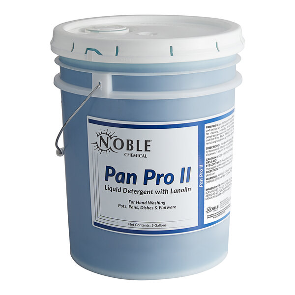 A 5 gallon bucket of Noble Chemical Pan Pro II liquid detergent on a counter in a professional kitchen.