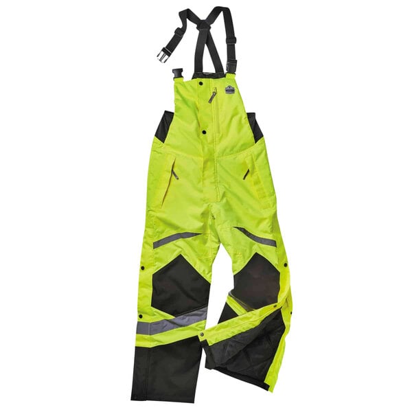 A pair of yellow and black Ergodyne GloWear insulated coveralls.