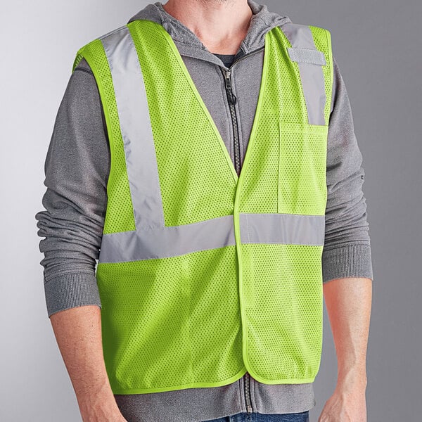 A man wearing an Ergodyne lime green reflective safety vest.