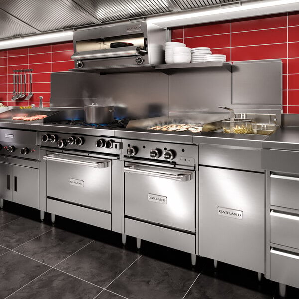A Garland natural gas salamander broiler mounted on a stainless steel range.