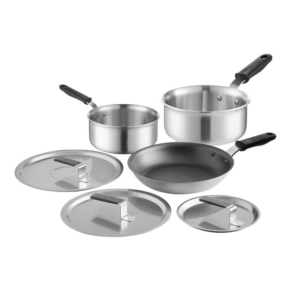 A group of stainless steel Vollrath cookware, including pots and pans with lids.