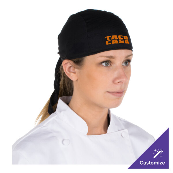 A chef wearing a black adjustable bandana under a chef's hat.
