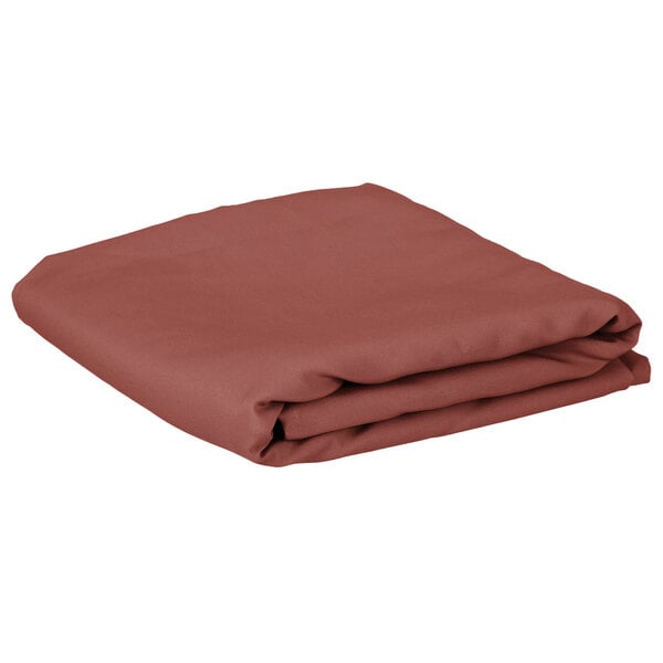 A folded mauve rectangular cloth table cover.