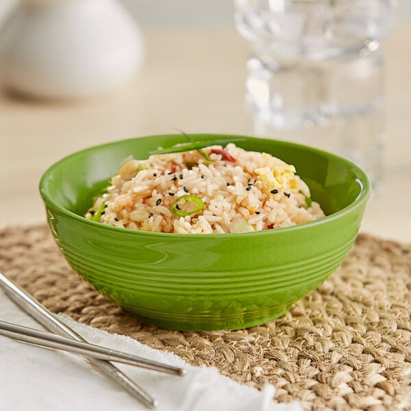 An Acopa Capri bamboo stoneware bowl filled with rice and vegetables with chopsticks on the side.