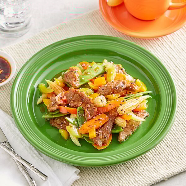 An Acopa Capri green stoneware plate with meat and vegetables on it.