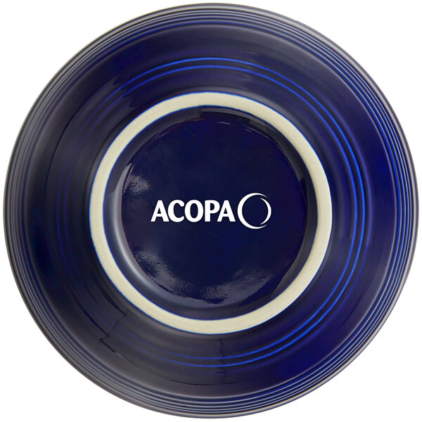 A deep blue Acopa stoneware bowl with white text on it.