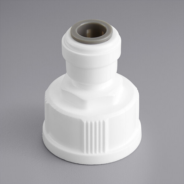 A white plastic pipe fitting with a grey cap.